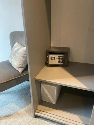 a small radio sitting on a shelf next to a bed at Spacious City Centre Property in Lancaster