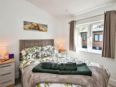 a bedroom with a bed and a window at Gerrida Lodge in Carnforth