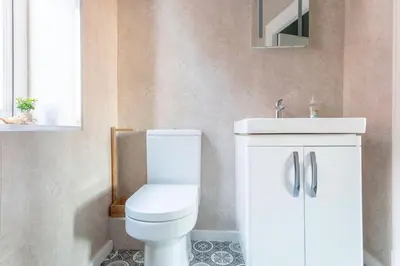 a bathroom with a white toilet and a sink at Beach Retreat in Lytham St Annes