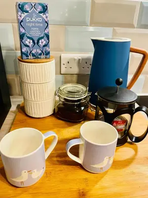 two coffee mugs sitting on a wooden counter top at Beach Retreat in Lytham St Annes