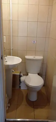 a bathroom with a white toilet and a sink at Lily Hotel in Blackpool