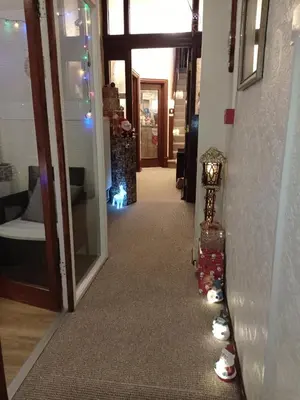 a hallway with christmas lights and christmas shoes on the wall at Lily Hotel in Blackpool