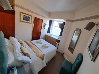 a hotel room with a bed and a mirror at Lily Hotel in Blackpool