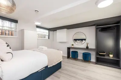 a bedroom with a bed and a desk and a mirror at Host & Stay - The Seel Street Townhouse in Liverpool