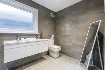 a bathroom with a sink and a toilet and a window at Host & Stay - The Seel Street Townhouse in Liverpool