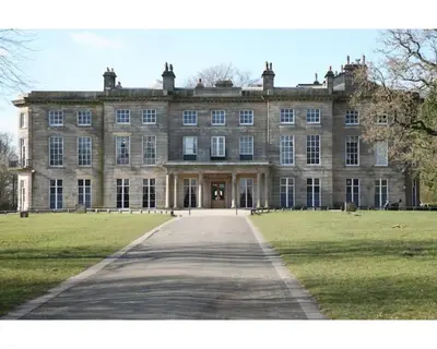 a large stone building with a pathway in front of it at Stylish 3 bedroom house only 5 mins from M6/M58 in Wigan