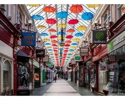 an alley with umbrellas hanging from a ceiling at Stylish 3 bedroom house only 5 mins from M6/M58 in Wigan