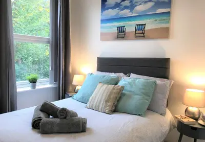 a bedroom with a bed with a stuffed animal on it at Central Wigan welcoming Townhouse sleeps up to 6 in Wigan