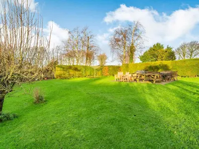 a picnic table in a field of green grass at The Shippon in Poulton le Fylde