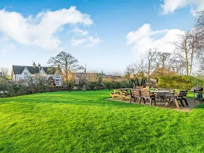 a park with tables and benches in the grass at The Hay Loft in Poulton le Fylde