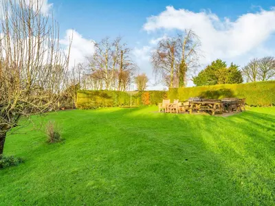 a picnic table in a field of green grass at The Granary in Poulton le Fylde