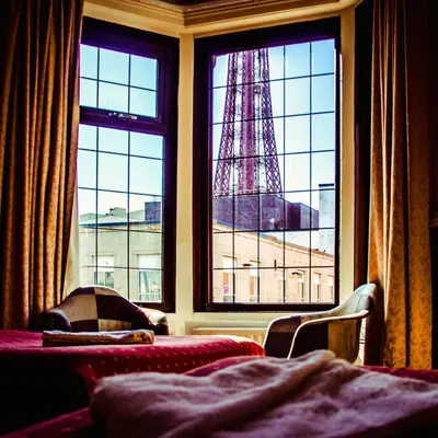 a bedroom with a eiffel tower seen through a window at Westholme Hotel in Blackpool