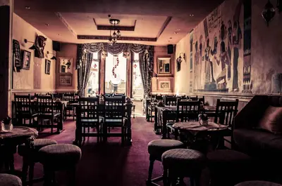 a restaurant with tables and chairs and a window at Westholme Hotel in Blackpool