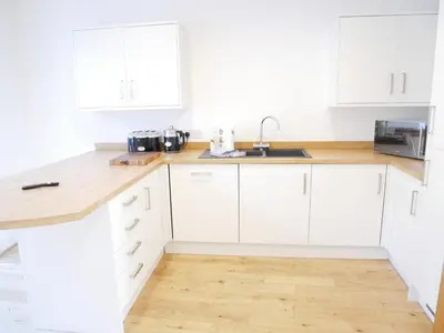 a white kitchen with white cabinets and a sink at The Ravens Inn, 4 - Bed, Sleeps 6, Pets Welcome in Ulverston