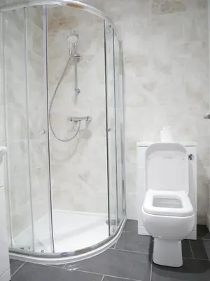 a bathroom with a shower and a toilet at The Ravens Inn, 4 - Bed, Sleeps 6, Pets Welcome in Ulverston