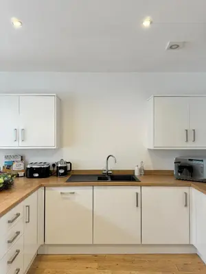 a kitchen with white cabinets and a sink at The Ravens Inn, 4 - Bed, Sleeps 6, Pets Welcome in Ulverston