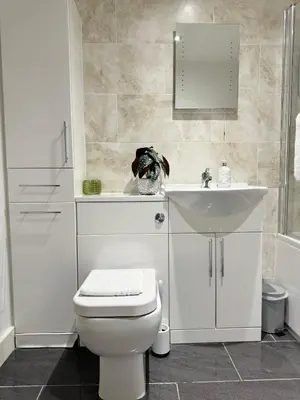a white bathroom with a toilet and a sink at The Ravens Inn, 4 - Bed, Sleeps 6, Pets Welcome in Ulverston