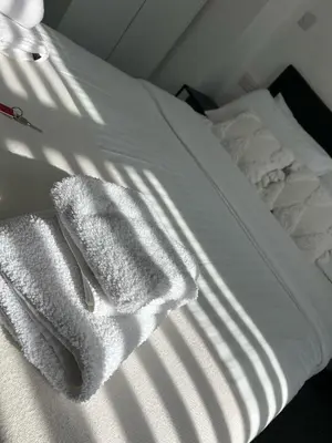 a white towel sitting on top of a bed at Alexandra Hotel in Blackpool