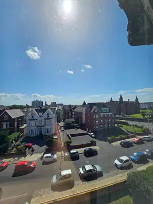 a city with cars parked in a parking lot at Avondale,2 bed lakeside on the Promenade, free parking & wifi in Southport