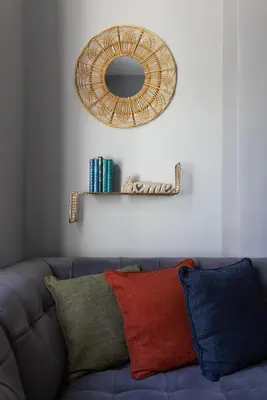 a mirror on a wall next to a couch at Arkles House - Air Host & Stay - Anfield in Liverpool