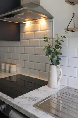 a kitchen counter with a vase with a plant in it at Arkles House - Air Host & Stay - Anfield in Liverpool