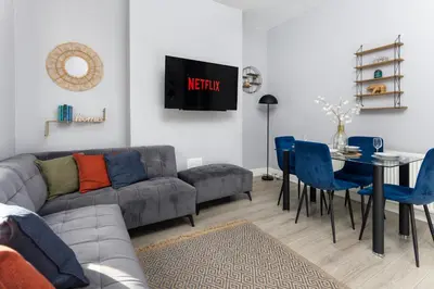 a living room with a couch and a table and chairs at Arkles House - Air Host & Stay - Anfield in Liverpool