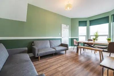 a living room with a couch and a table at Queen Street Apartments by Sasco in Blackpool