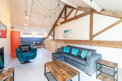 a living room with a couch and a table at Carriage Works by Guestz in Preston