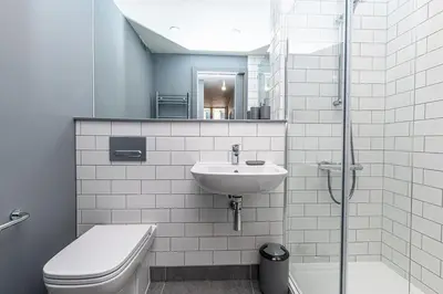a white bathroom with a sink and a toilet at Carriage Works by Guestz in Preston