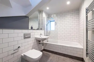 a bathroom with a toilet and a sink and a tub at Carriage Works by Guestz in Preston