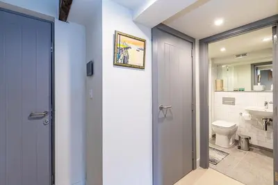 a bathroom with a door leading to a toilet at Carriage Works by Guestz in Preston