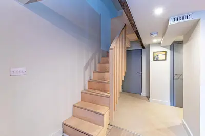a staircase in a hallway with blue ceilings at Carriage Works by Guestz in Preston