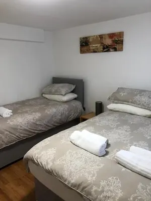 a room with two beds and a picture on the wall at 4 bed city centre flat in Liverpool