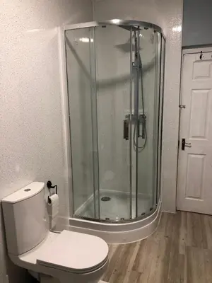 a bathroom with a glass shower and a toilet at 4 bed city centre flat in Liverpool