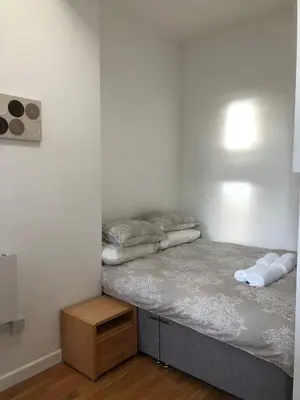 a small bedroom with a bed with two pillows at 4 bed city centre flat in Liverpool