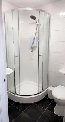 a bathroom with a shower and a toilet at CityNights Studios with Free Parking in Liverpool