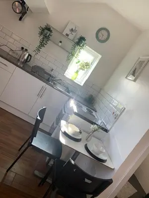 a kitchen with a counter and a table and chairs at CityNights Studios with Free Parking in Liverpool