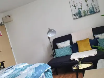 a living room with a couch and a table at CityNights Studios with Free Parking in Liverpool