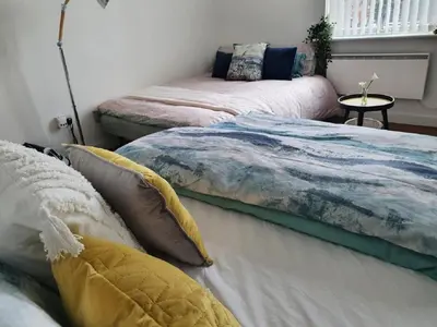 two beds sitting in a room with ainylinylinylinylinyl at CityNights Studios with Free Parking in Liverpool