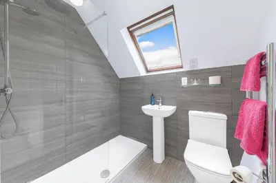 a bathroom with a toilet and a sink and a shower at Gorgeous Cottage near Cartmel with FREE SPA Access in Holker