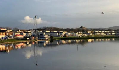 a large body of water with houses and condos at Plot 8 Lakeside Cabin, Wyldecrest, Millom in Millom