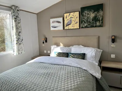 a bedroom with a large bed and a window at Coniston View 7 in Warton