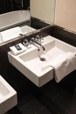 a white sink in a bathroom with a mirror at 62 Castle Street Hotel in Liverpool