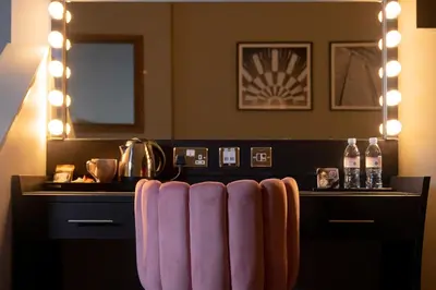 a room with a bar with a table with lights at 62 Castle Street Hotel in Liverpool