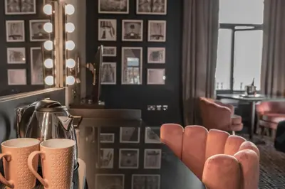 a living room with a table with two cups on it at 62 Castle Street Hotel in Liverpool