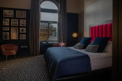 a bedroom with a large bed and a window at 62 Castle Street Hotel in Liverpool