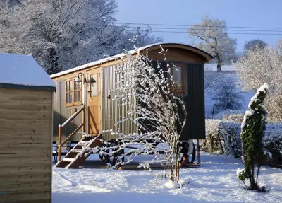 a play house in the snow with a tree at Woody's Retreat in Bolton by Bowland