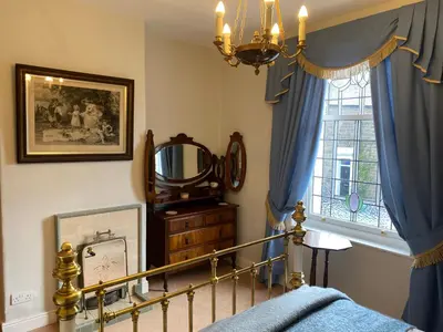 a bedroom with a bed and a mirror and a window at Number 19 - Victorian Town House in Clitheroe