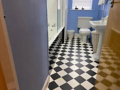 a bathroom with a black and white checkered floor at Number 19 - Victorian Town House in Clitheroe