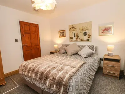 a bedroom with a bed and a wooden door at Bella Vita in Southport